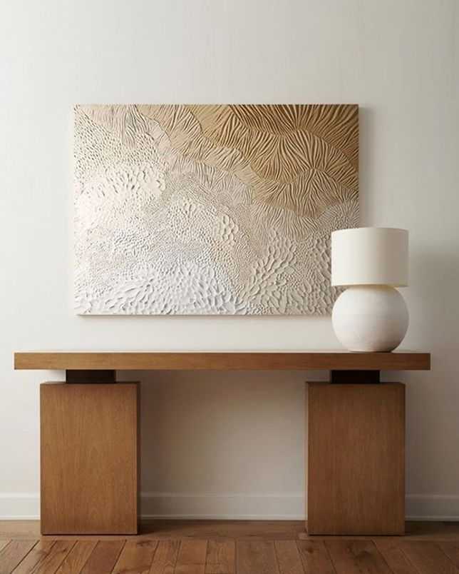 modern console table in entryway with art above